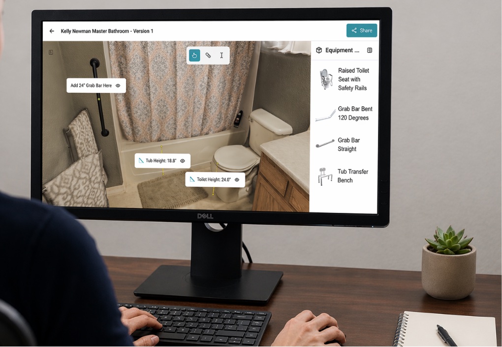 An assessor measuring a scanned bathroom from a desktop monitor